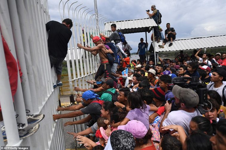Caravan smashes through Mexican border